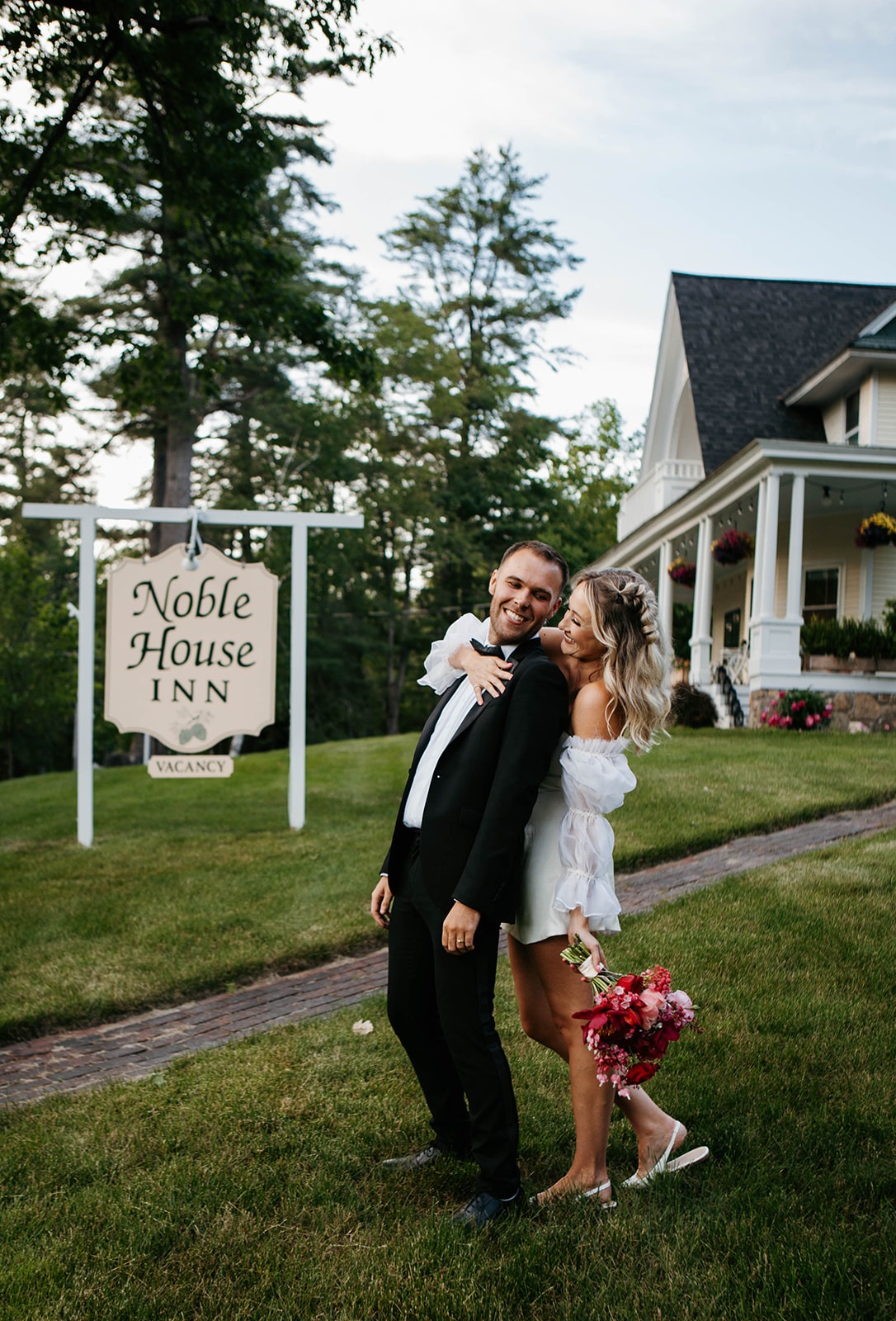 bride and groom in front of noble house inn