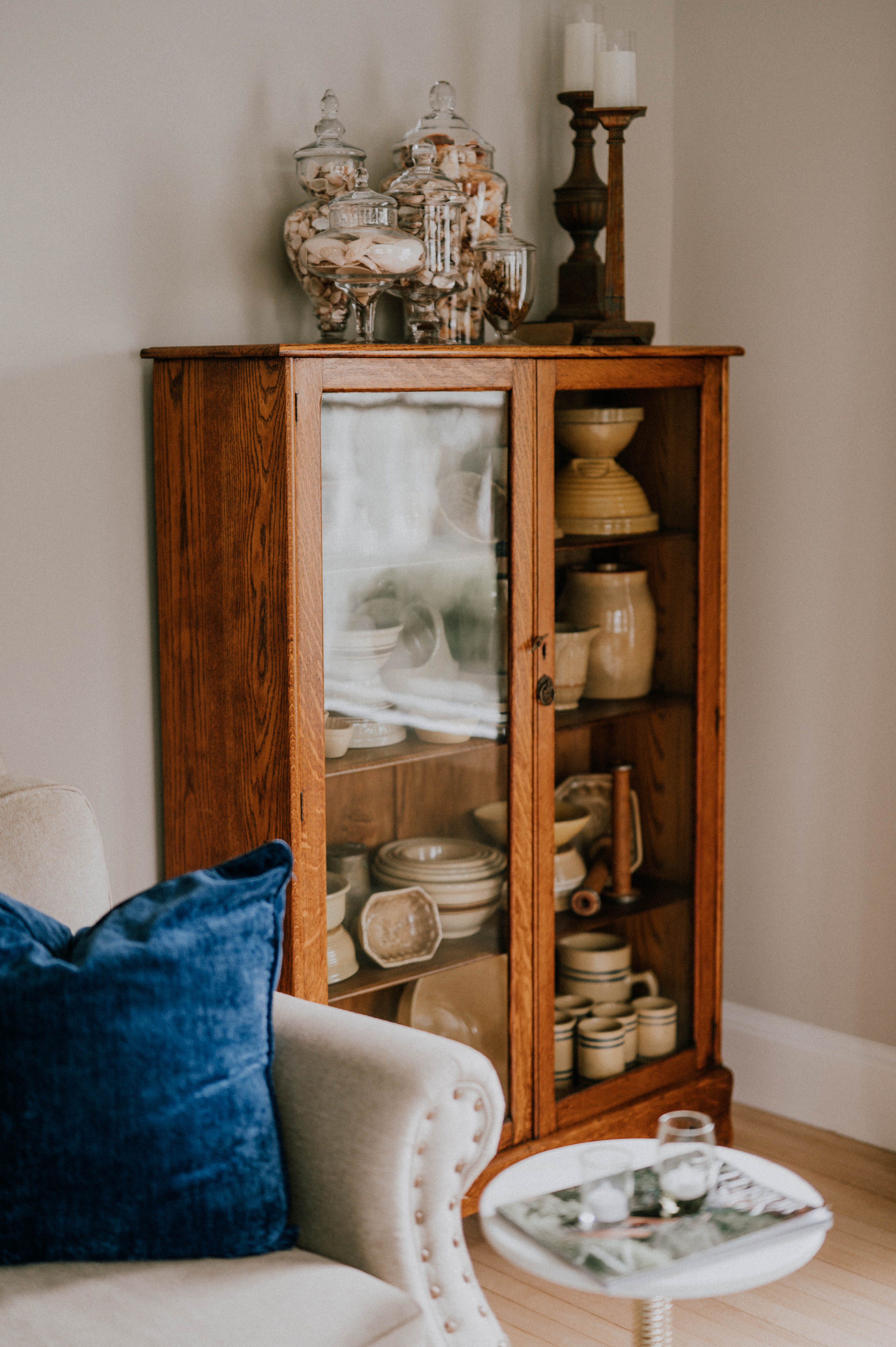 antique crocks in glass cabinet