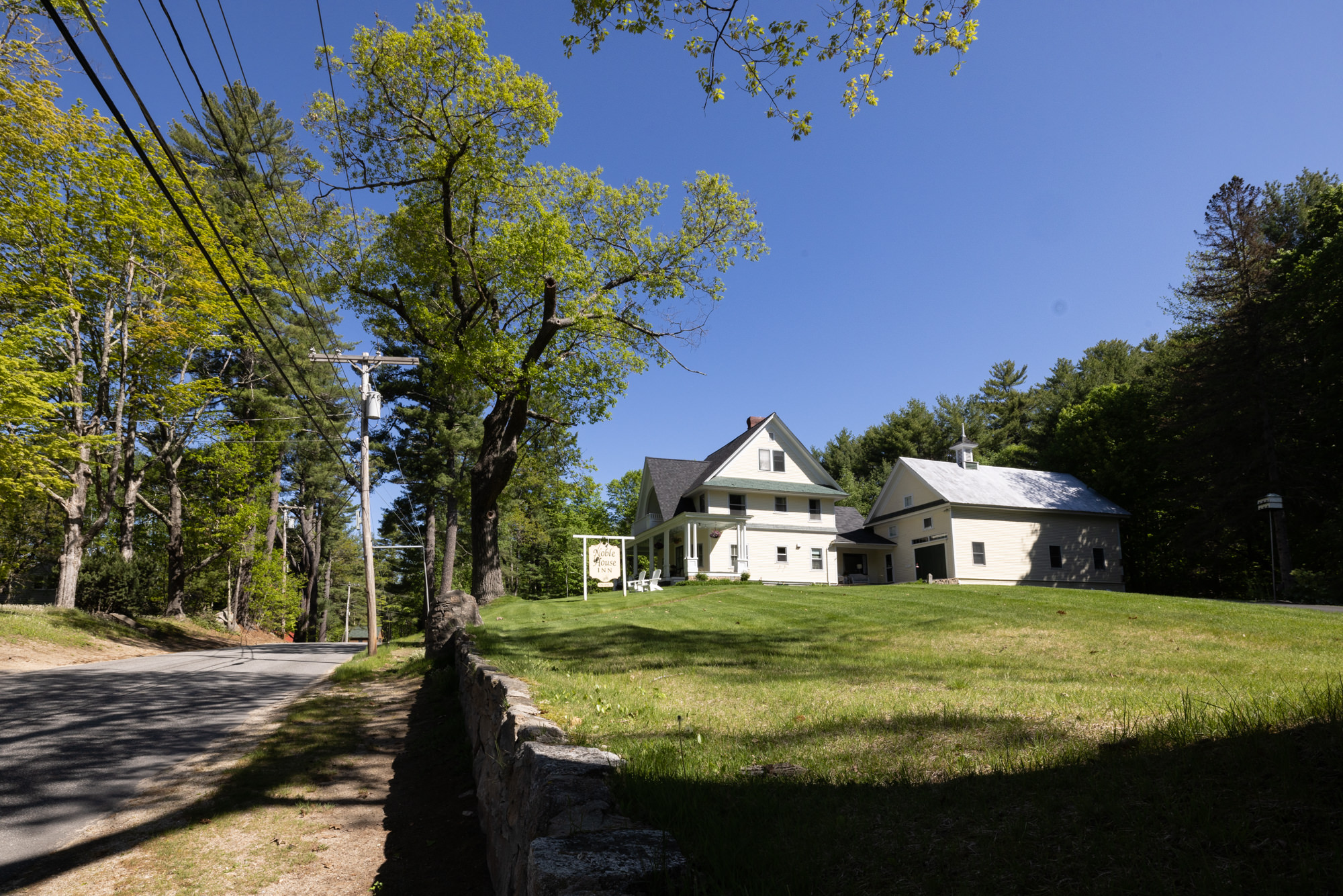 country road leading up to noble house inn
