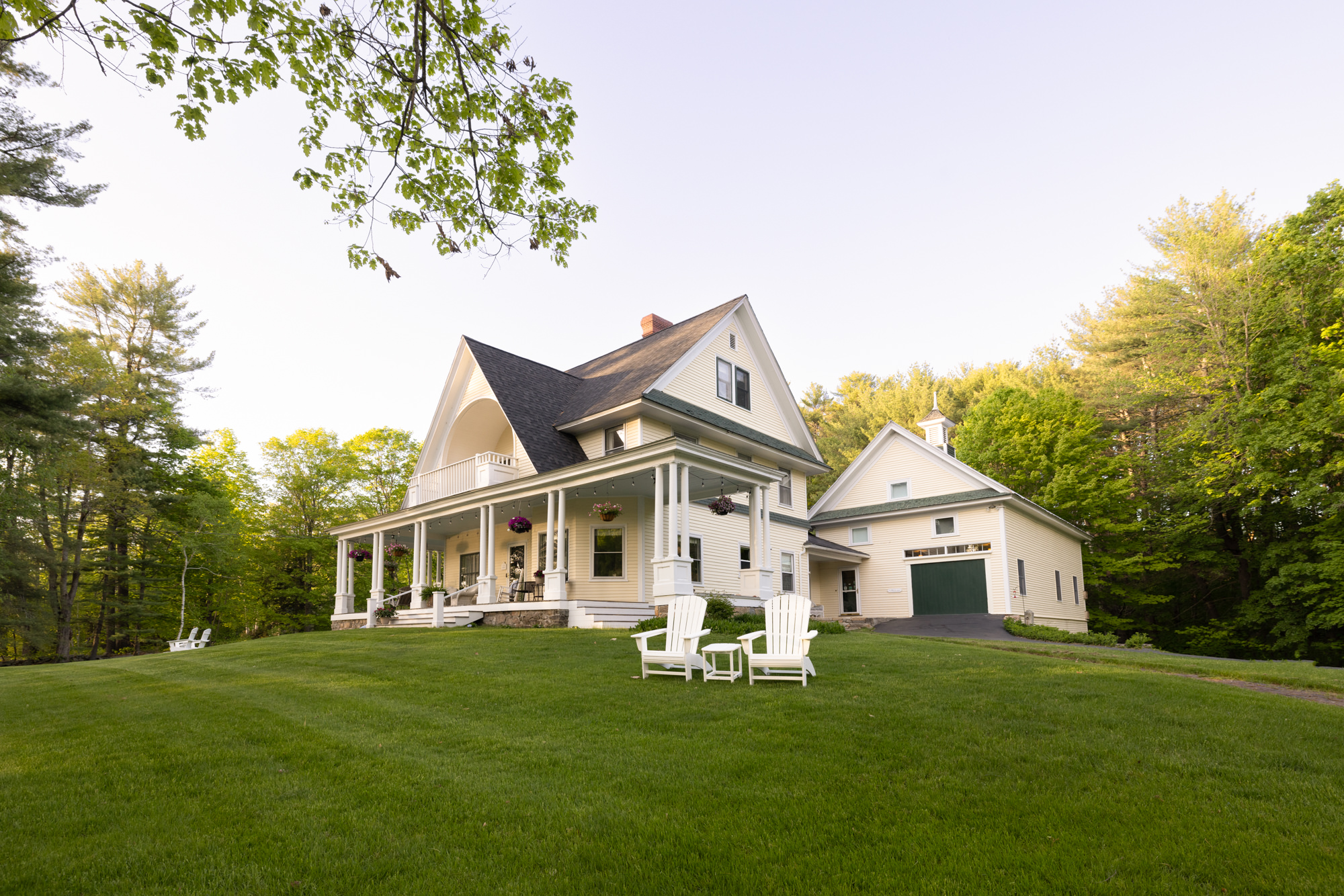 exterior of noble house inn with Adirondack chairs and spacious porch