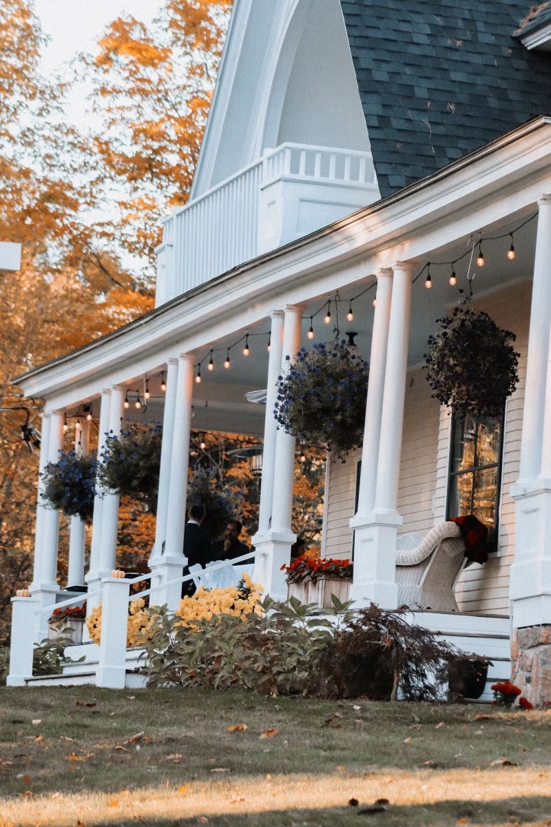 spacious front porch with bistro lights at noble house inn